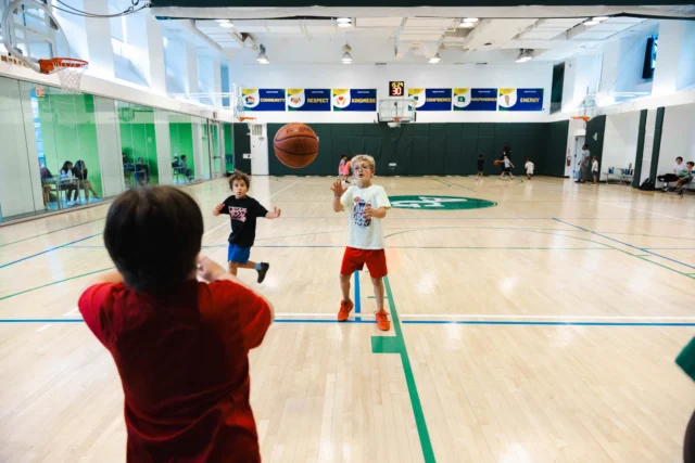 Children playing in Asphalt Green's Everyone Plays: Basketball class.