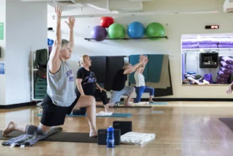Older Adult practicing Vinyasa Yoga