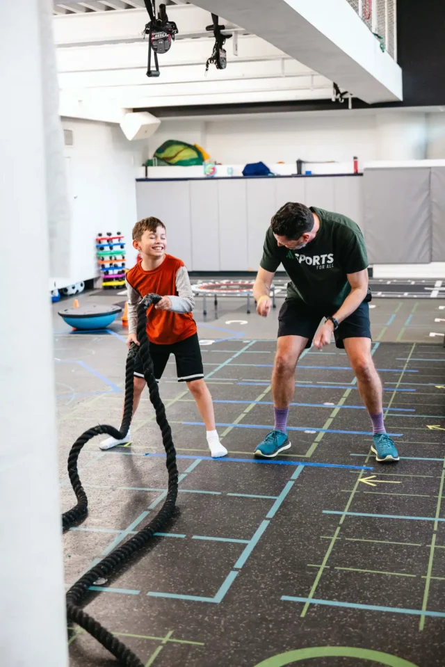 A young boy and and coach in Asphalt Green's Playground Pathways class.