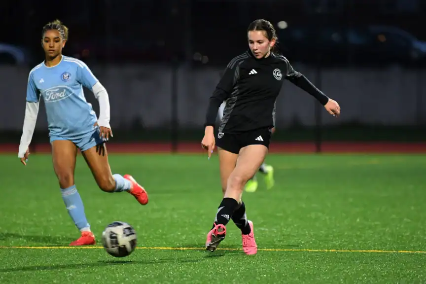 An AGSC girls youth soccer play competes during a game.