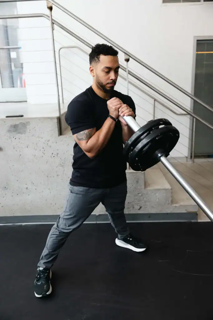 AG fitness trainer performs the landmine cossack squat exercise.