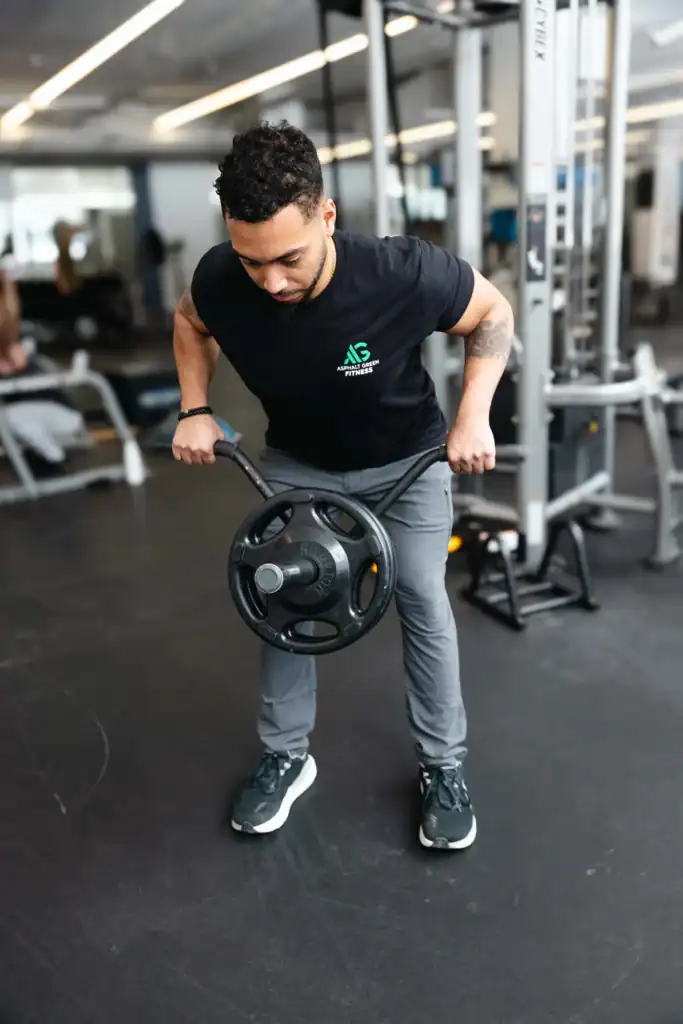 AG Fitness trainer performs the landmine bent over row exercise.