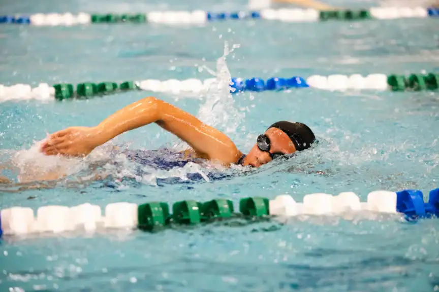 Child swimming laps in a pool.
